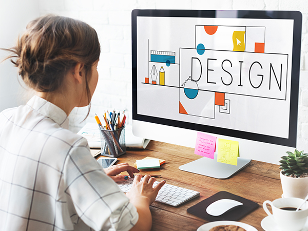 a girl is designing a logo on computer